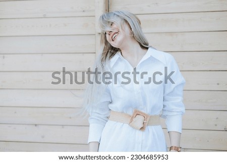 Beautiful successful rich middle aged woman posing on the street photo shoot