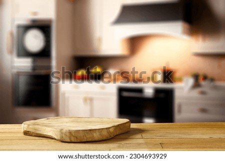 Wooden desk of free space for your decoration and blurred kitchen background in home interior. 