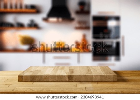 Wooden desk of free space for your decoration and blurred kitchen background in home interior. 