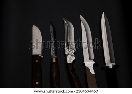 Damascus steel knives on a black background. Kitchen knives. background with japanese knife. A set of Japanese Damascus steel knives. Banner Royalty-Free Stock Photo #2304694469