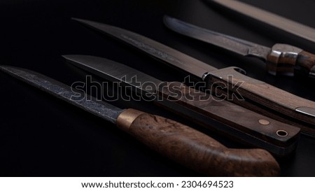 Damascus steel knives on a black background. Kitchen knives. background with japanese knife. A set of Japanese Damascus steel knives. Banner
