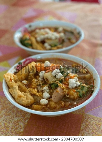 Close up picture of sundanese special curry noodle with extra toppings in it