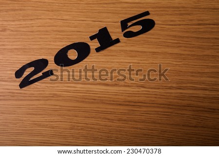 Inscription 2015 on flour on a wooden table