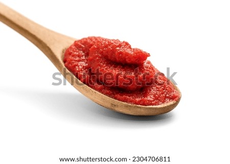 Natural tomato puree in wooden spoon isolated on white, including clipping path Royalty-Free Stock Photo #2304706811