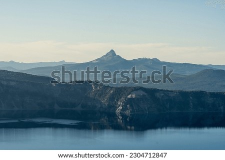 Cliffs Over Crater Lake With Mt. Thielsen In The Distance in Summer Royalty-Free Stock Photo #2304712847