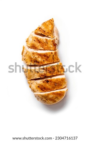 Grilled chicken breast. Sliced spicy roasted chicken fillet isolated on white background. Royalty-Free Stock Photo #2304716137