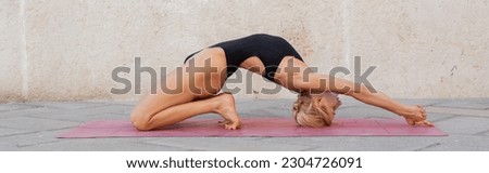 Side view of fit woman practicing little thunderbolt yoga pose on mat outdoors in Italy, banner