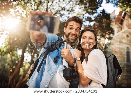 Tourist couple, smile and selfie outdoor for travel in a city for vacation memory or happiness. Happy man and woman take picture on adventure, social media or holiday trip with freedom, love and care