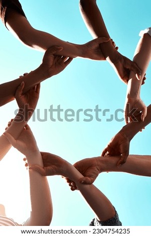Hands, link and circle with teamwork and blue sky with low angle, solidarity and trust with arm chain and people together. Team, motivation and connection with group collaboration and community Royalty-Free Stock Photo #2304754235
