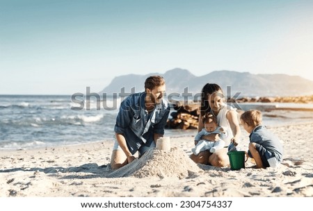 Sandcastle, happy summer and children at the beach with bonding, love and support. Baby, mom and dad together with kids playing in the sun with mockup space and smile by the ocean and sea with family Royalty-Free Stock Photo #2304754337