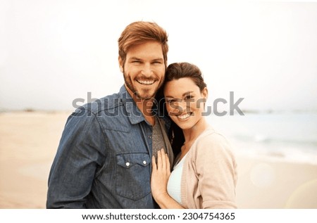 Couple, portrait and embrace at beach for travel, romance and freedom together outdoors. Face, smile and happy woman hugging man on trip, vacation or holiday, bond or having fun standing in Bali