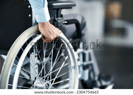 Wheelchair, disability and man hand holding wheel in a hospital for healthcare. Disabled, mobility problem and male person in a clinic for support and medical care with hands of patient and mockup Royalty-Free Stock Photo #2304754665