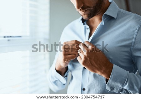 Closeup, man and button shirt of clothes for job interview, work and corporate fashion for business. Hands of male person getting ready in professional outfit from wardrobe in the morning at home Royalty-Free Stock Photo #2304754717