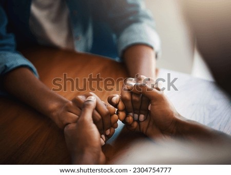 Empathy, prayer and support with friends and holding hands for comfort, kindness and gratitude. Hope, help and trust with closeup of people at home for depression, praying and forgiveness Royalty-Free Stock Photo #2304754777