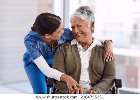 Healthcare, disability and a nurse hugging an old woman in a wheelchair during a nursing home visit. Medical, hug and funny with a laughing female medicine professional talking to a senior resident Royalty-Free Stock Photo #2304755331