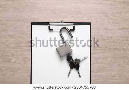 Top secret. Clipboard with padlock on table Royalty-Free Stock Photo #2304755703