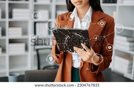 Businesswoman hand working digital marketing media in virtual screen with mobile phone and modern compute with VR icon diagram at office in morning light