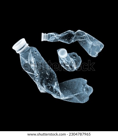 Plastic bottles in the air on a black background Royalty-Free Stock Photo #2304787965