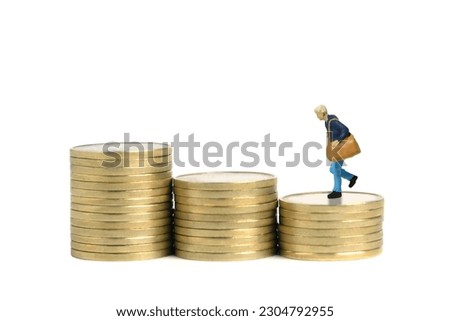 Miniature tiny people toy figure photography. A student running above coin money stack stairway. Isolated on white background. Image photo