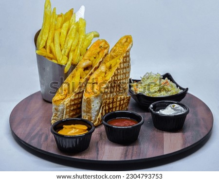 French tacos with french fries with ketchup and mayonnaise. isolated on a white background