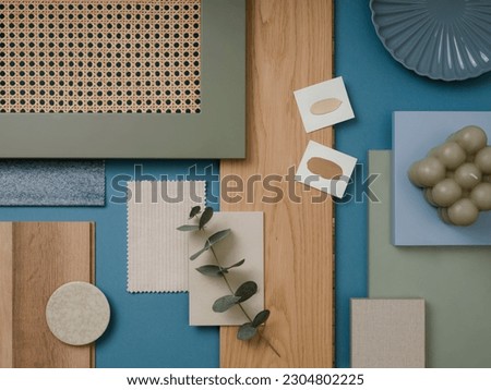Creative flat lay composition in blue, gray and brown color palette with textile and paint samples, lamella panels and tiles. Architect and interior designer moodboard. Top view. Copy space. 