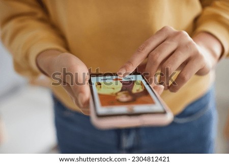 Woman using dating app, swiping and liking photos of users. Close up shot of female hands using smartphone to find love, partner or boyfriend. Find love online concept