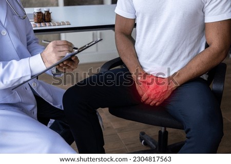 A man with an enlarged prostate examines and consults a doctor. The doctor asks about the patient's illness and gives health advice. Royalty-Free Stock Photo #2304817563
