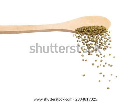 Green mung beans fall down in wooden spoon, green mung bean float explode, abstract cloud fly. Dried green mung beans splash throwing in Air. White background Isolated high speed shutter, freeze