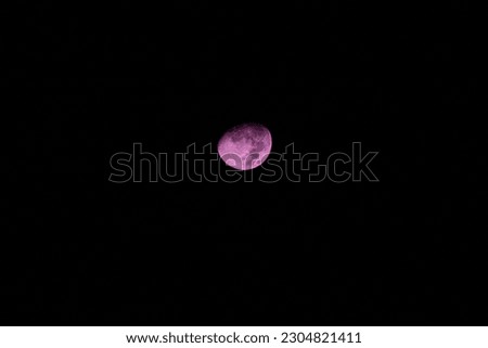 Perfect pink moon on black background