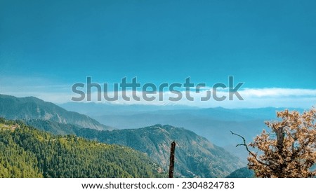 Mountains and sky with slight cloud blue Royalty-Free Stock Photo #2304824783