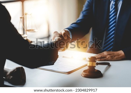 Portrait of lawyers agreeing holding hands in lawyer office giving advice and advice on case consulting concept Royalty-Free Stock Photo #2304829917