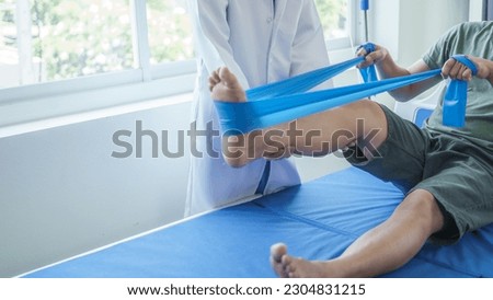 Professional massage therapist physiotherapy worker rehabilitation physiotherapy man at work with patient man client at clinic Royalty-Free Stock Photo #2304831215