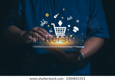 Hand holding virtual info graphics with trolley cart icons , Technology online shopping business concept. Royalty-Free Stock Photo #2304831551