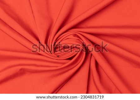 Swirled red-colored fabric texture background. This fabric is made of polyester and spandex. Royalty-Free Stock Photo #2304831719