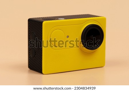 High definition sport camera yellow camera isolated on brown background