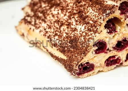 triangular cake with cherries on plate. Food recipe background. Close up.