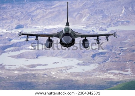 A U.S. Air Force F-16 Fighting Falcon from Eielson Air Force Base flies in formation over the Joint Pacific Alaska Range Complex Royalty-Free Stock Photo #2304842591
