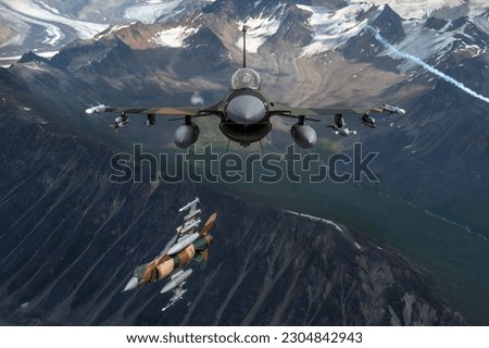 U.S. Air Force F-16 Fighting Falcons from Eielson Air Force Base, fly in formation over the Joint Pacific Alaska Range Complex Royalty-Free Stock Photo #2304842943