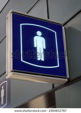 A illuminated sign showing the sign of the men restroom in Hong Kong.