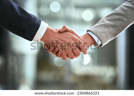 Business man, partner and handshake in meeting, corporate welcome and introduction or lawyer agreement and success. Professional people or clients shaking hands for night b2b, interview or legal deal Royalty-Free Stock Photo #2304866321