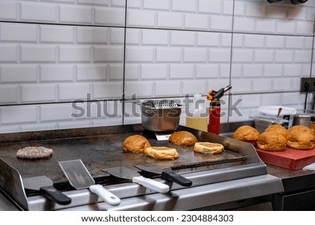 master working in the kitchen making hamburgers