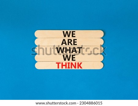 We are what we think symbol. Concept word We are what we think on wooden stick. Beautiful blue table blue background. Business We are what we think concept. Copy space.