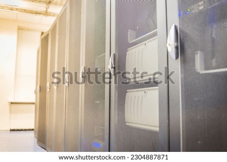 Network cabinets neatly arranged in the data center room.