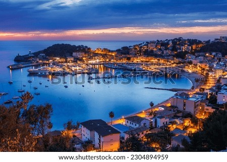 Port de Soller during sunset. Beautiful dusk at travel destination in Mallorca, Spain. Illuminated old town of the Balearic Islands Royalty-Free Stock Photo #2304894959