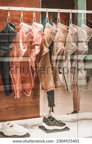 Multicolored men's pants, clothes on hanger in store, store window, selective focus. Shopping