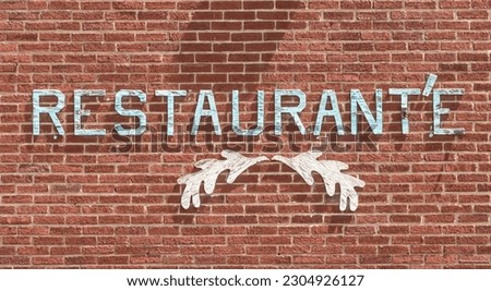A wooden Restaurant'e sign on a brick wall in Sheffield, Pennsylvania, USA on a sunny spring day