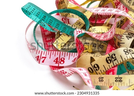 Measuring tapes on white background.