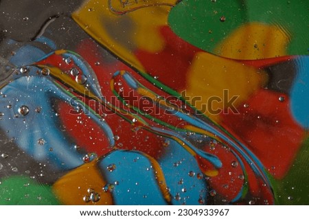Abstract photography. Color spots are red, blue, yellow, green, black, white, silvery. Drops, objects on the surface. Photos for the background, for design, for interior design.