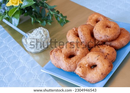 Indian Origin, Srilankan Wadei (Medu Vadei) is so tasty with a scraped Coconut sour and salt Chutney. It's deep fried and crunchy when you eat it freshly fried. Royalty-Free Stock Photo #2304946543