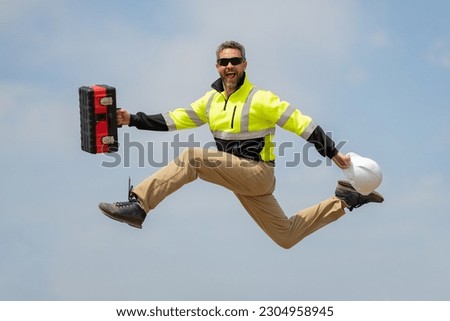 Fast building. Funny construction worker jumping. Excited jump of builders in helmet. Worker in hardhat. Construction engineer in builder uniform jump. Excited foreman jump. Speed build. Royalty-Free Stock Photo #2304958945